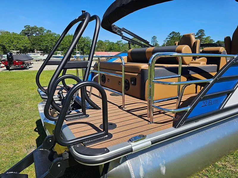 Slide: The Image of 2025 Bentley Pontoons 223 Elite Swingback Tritoon with dual captain seats on grassy area. - 9
