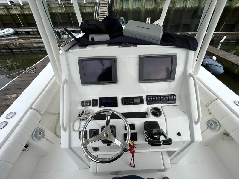 Slide: The Image of Helm of 2014 Regulator 34 boat with dual screens and steering wheel. - 13