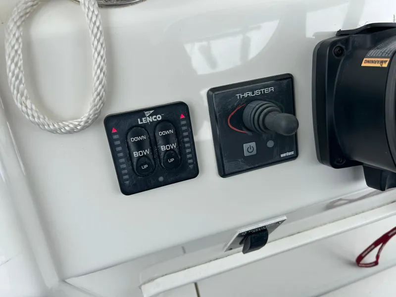 Slide: The Image of Control panel of a 2014 Regulator 34 boat with Lenco and thruster controls. - 17