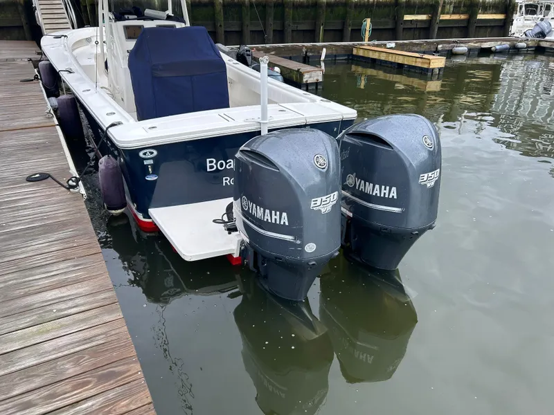 Slide: The Image of 2014 Regulator 34 boat with twin Yamaha 350 engines docked in marina. - 20