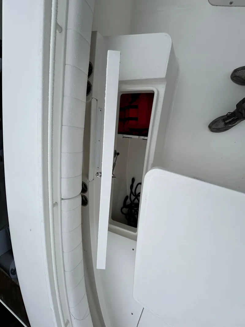 Slide: The Image of 2014 Regulator 34 boat storage compartment with open hatch and visible ropes. - 22