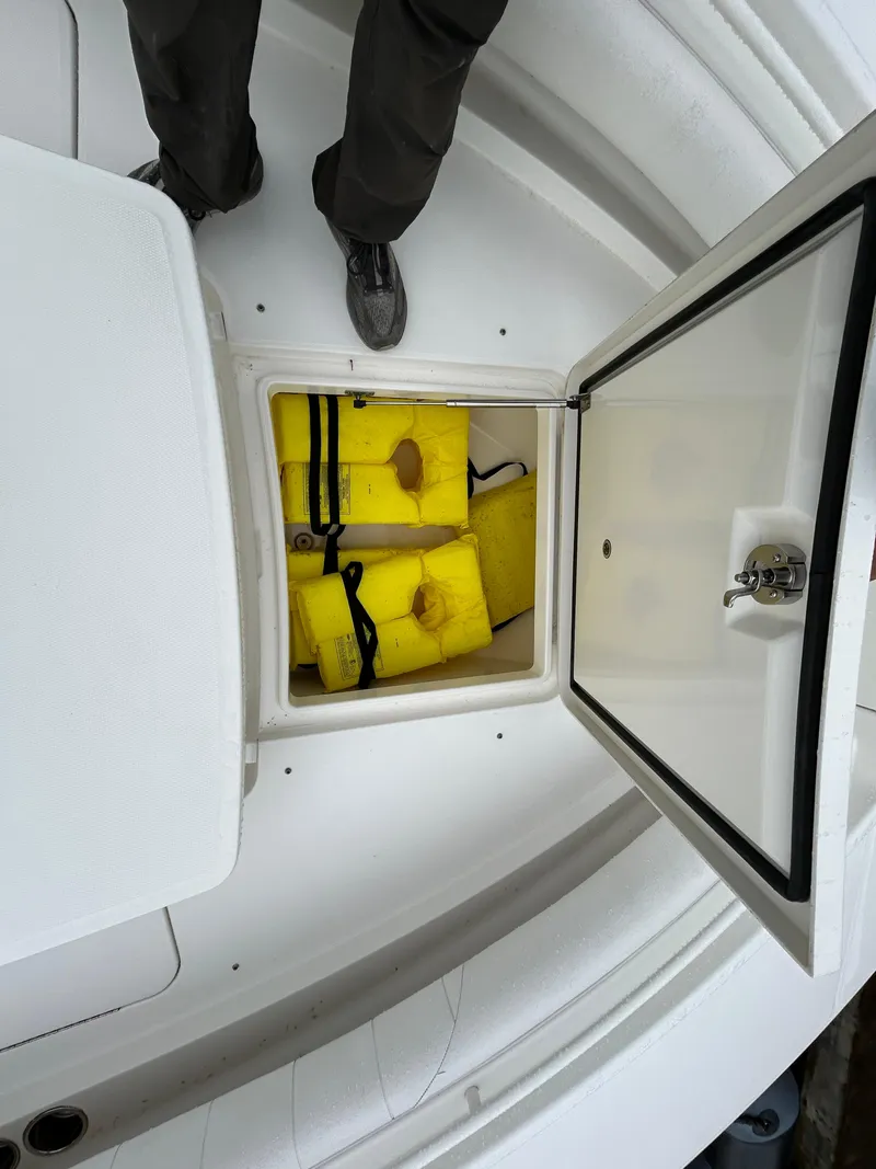 Slide: The Image of 2014 Regulator 34 boat storage compartment with yellow life jackets. - 23