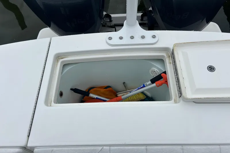 Slide: The Image of Storage compartment on a 2014 Regulator 34 boat with cleaning tools inside. - 29
