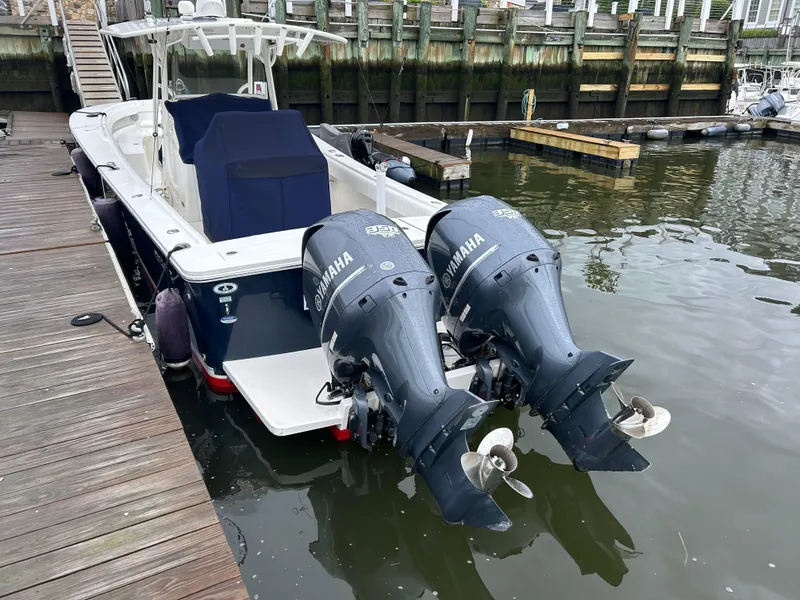 Slide: The Image of 2014 Regulator 34 boat with twin Yamaha outboard engines docked at marina. - 3
