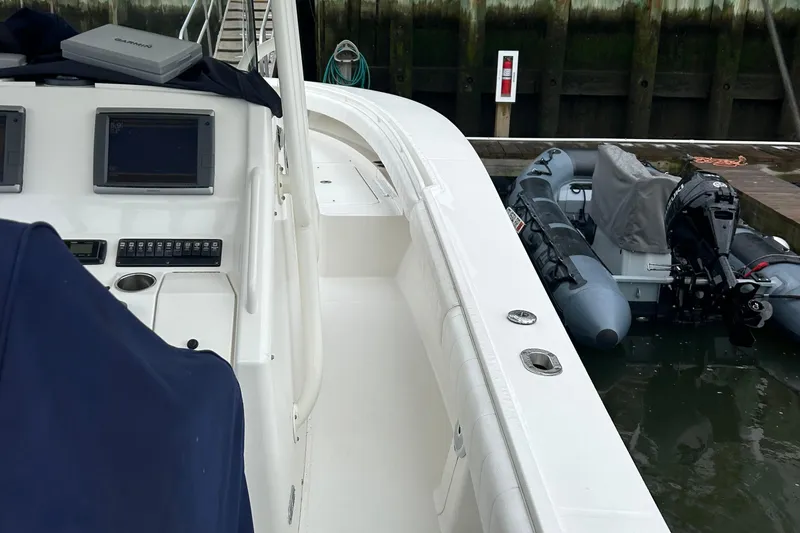 Slide: The Image of 2014 Regulator 34 boat interior with control panel and docked inflatable boats. - 31