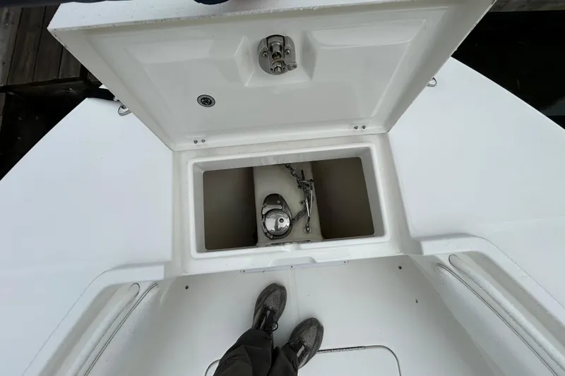 Slide: The Image of 2014 Regulator 34 boat anchor compartment with open hatch, viewed from above. - 34