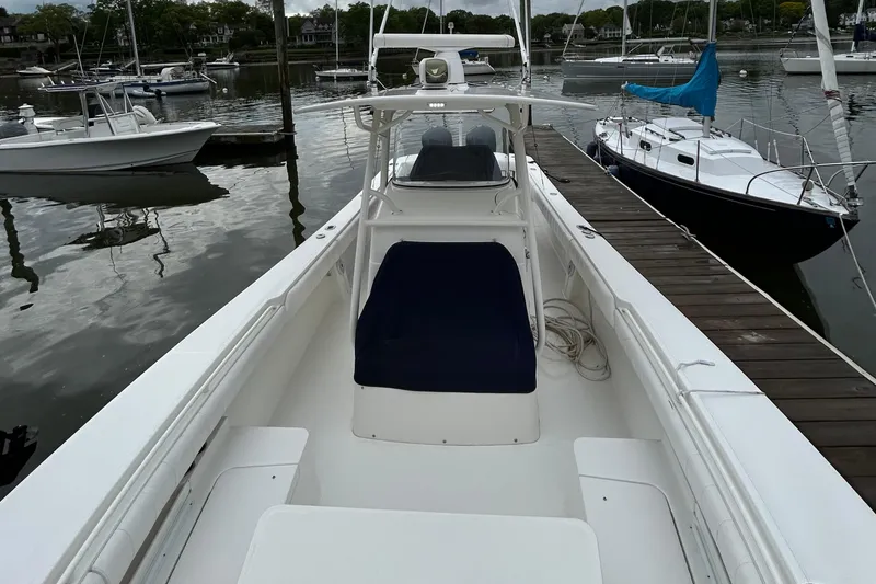 Slide: The Image of 2014 Regulator 34 boat docked at marina, featuring spacious deck and seating. - 35