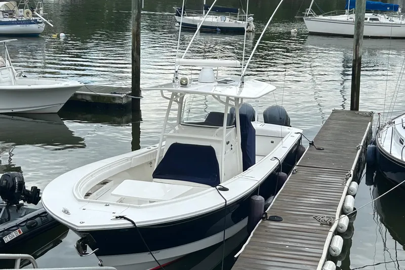Slide: The Image of 2014 Regulator 34 boat docked at a marina with other vessels nearby. - 6
