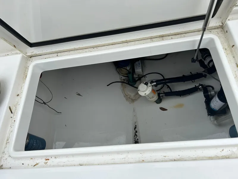 Slide: The Image of Open storage compartment of 2014 Regulator 34 boat, showing internal wiring and components. - 7