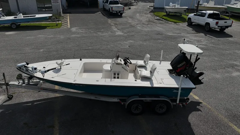 Slide: The Image of 1999 Maverick 21 Master Angler boat on trailer in parking lot. - 7