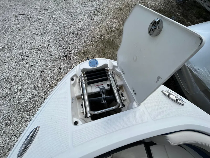 Slide: The Image of 2018 Chaparral Vortex 243 boat with open anchor storage compartment on deck. - 13