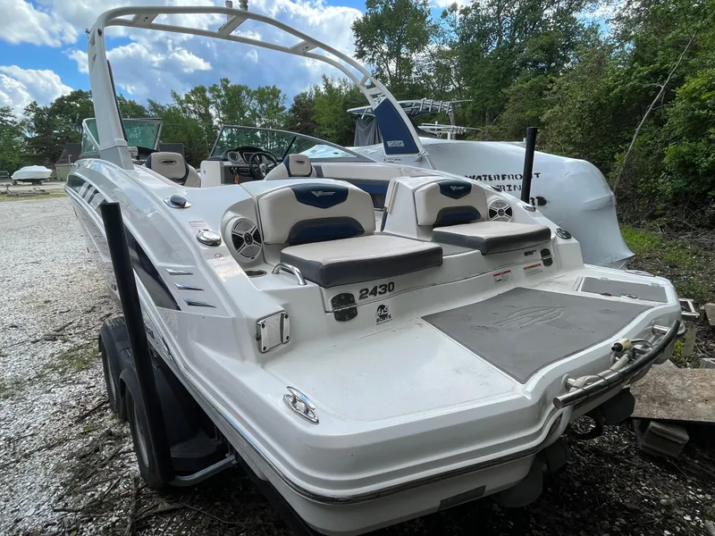 Slide: The Image of 2018 Chaparral Vortex 243 boat with sleek design, white exterior, and spacious seating. - 2