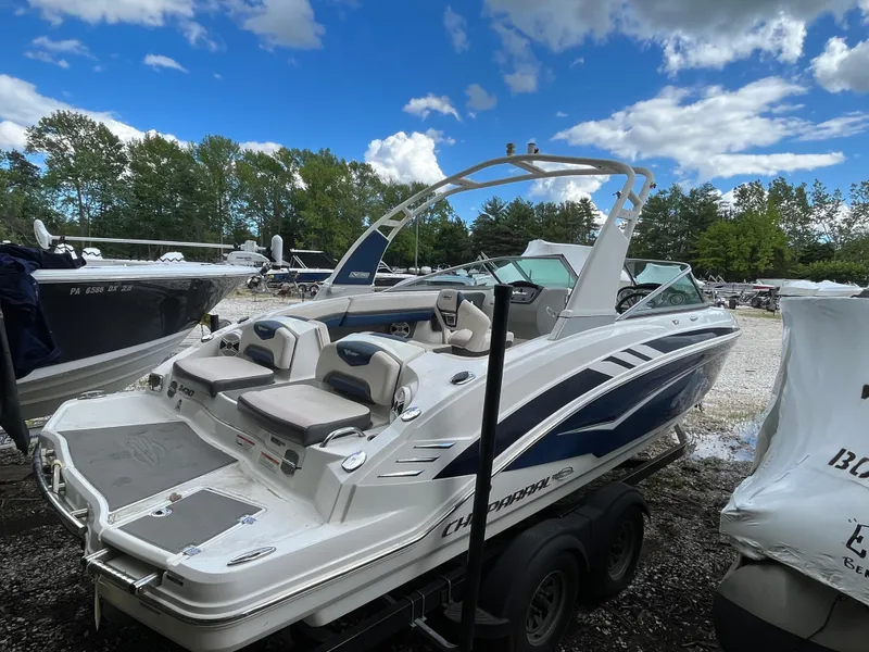 Slide: The Image of 2018 Chaparral Vortex 243 boat on trailer under a blue sky with clouds. - 3