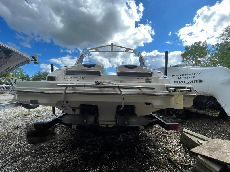 Slide: The Image of 2018 Chaparral Vortex 243 boat, rear view, parked outdoors under cloudy sky. - 4