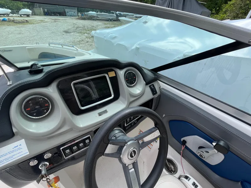 Slide: The Image of 2018 Chaparral Vortex 243 boat dashboard with steering wheel and control panel. - 8