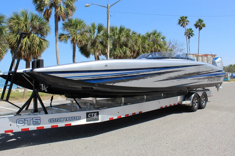 Slide: The Image of 2025 Fountain 34 Thundercat boat on trailer, parked near palm trees. - 5