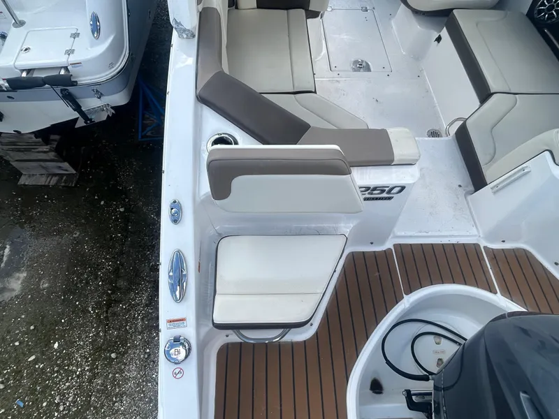 Slide: The Image of 2019 Chaparral 250 Suncoast boat interior with seating and deck view. - 10