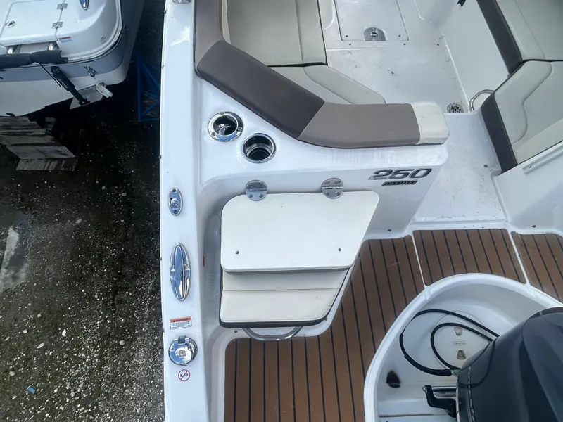 Slide: The Image of 2019 Chaparral 250 Suncoast boat interior with seating and deck details. - 11