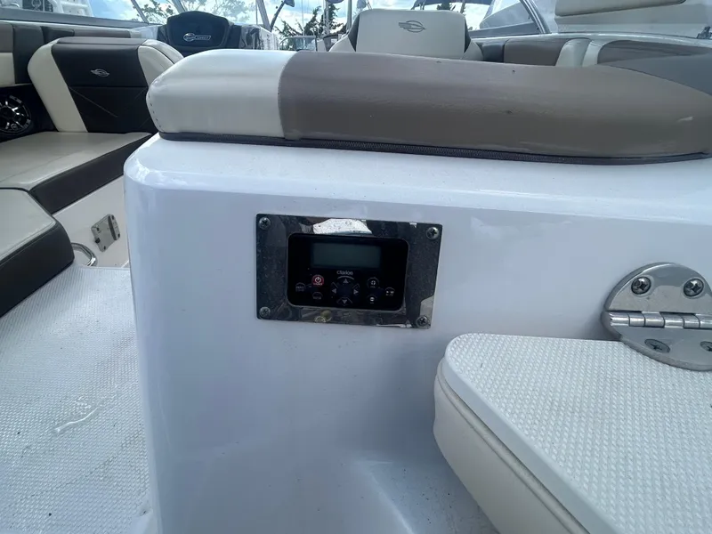 Slide: The Image of 2019 Chaparral 250 Suncoast boat interior with seating and control panel. - 12
