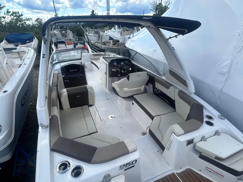 Slide: The Image of 2019 Chaparral 250 Suncoast boat with spacious seating and modern dashboard. - 13