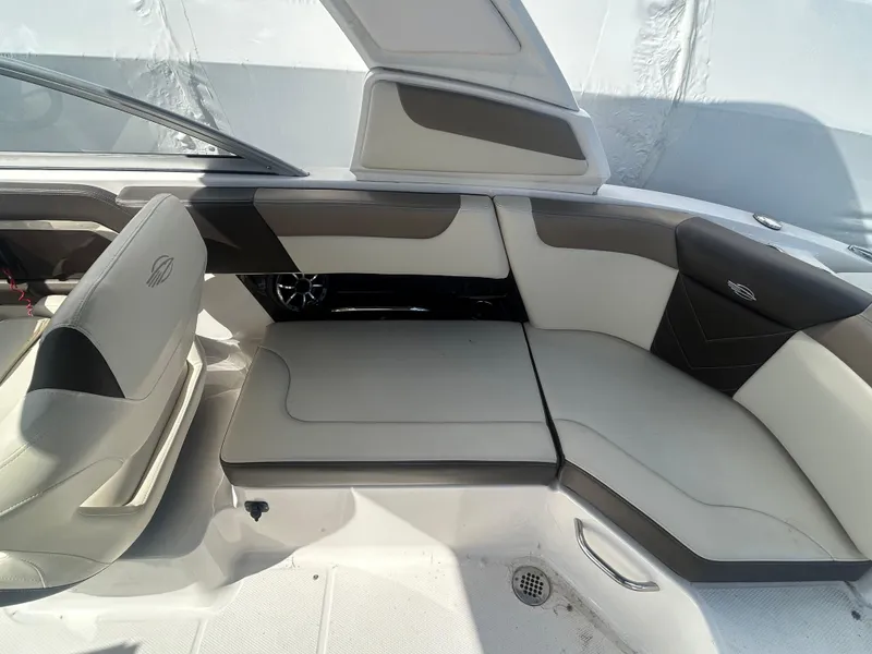 Slide: The Image of 2019 Chaparral 250 Suncoast boat interior with white and gray seating. - 18