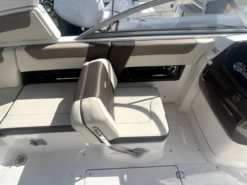 Slide: The Image of 2019 Chaparral 250 Suncoast boat interior with beige and brown seating. - 19