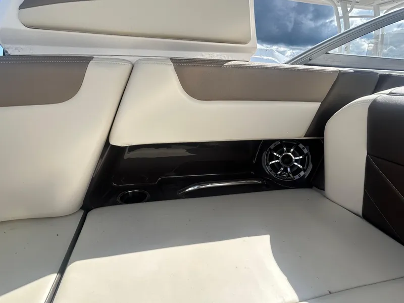 Slide: The Image of 2019 Chaparral 250 Suncoast boat interior with beige and brown seating. - 26