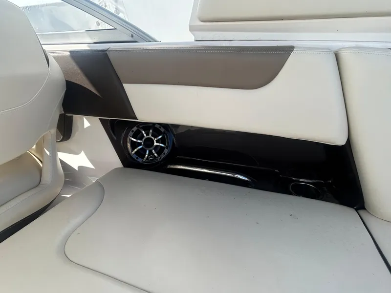 Slide: The Image of 2019 Chaparral 250 Suncoast interior with beige seating and speaker detail. - 27