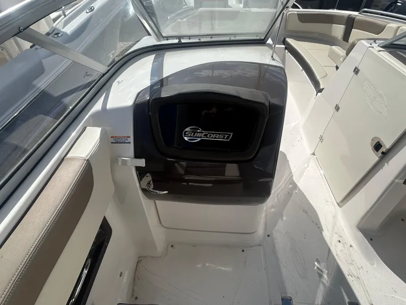 Slide: The Image of 2019 Chaparral 250 Suncoast boat interior with seating and Suncoast logo. - 28