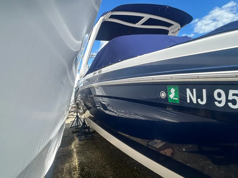 Slide: The Image of 2019 Chaparral 250 Suncoast boat in storage, blue hull, New Jersey registration. - 3