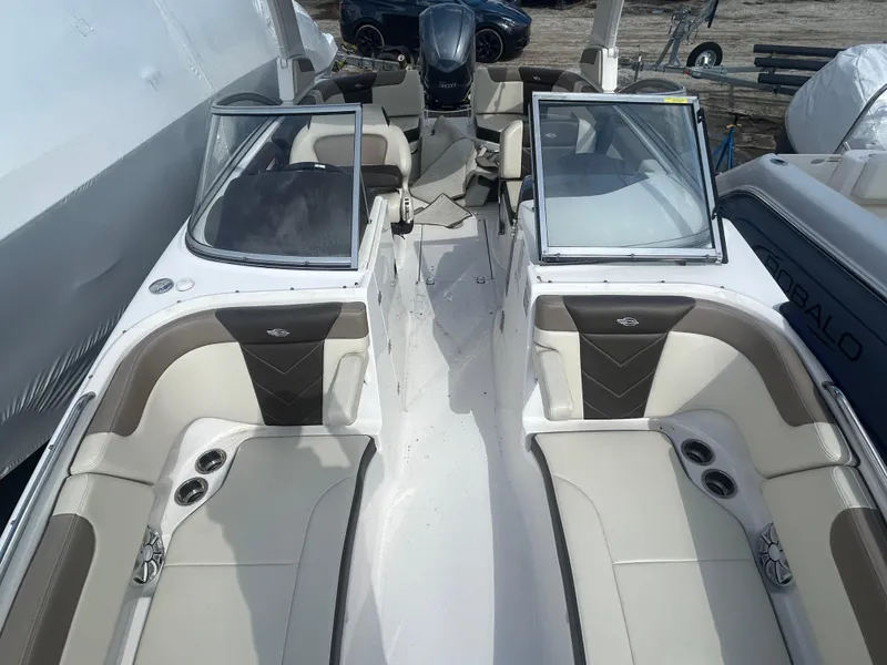 Slide: The Image of 2019 Chaparral 250 Suncoast boat interior with open seating and cup holders. - 33