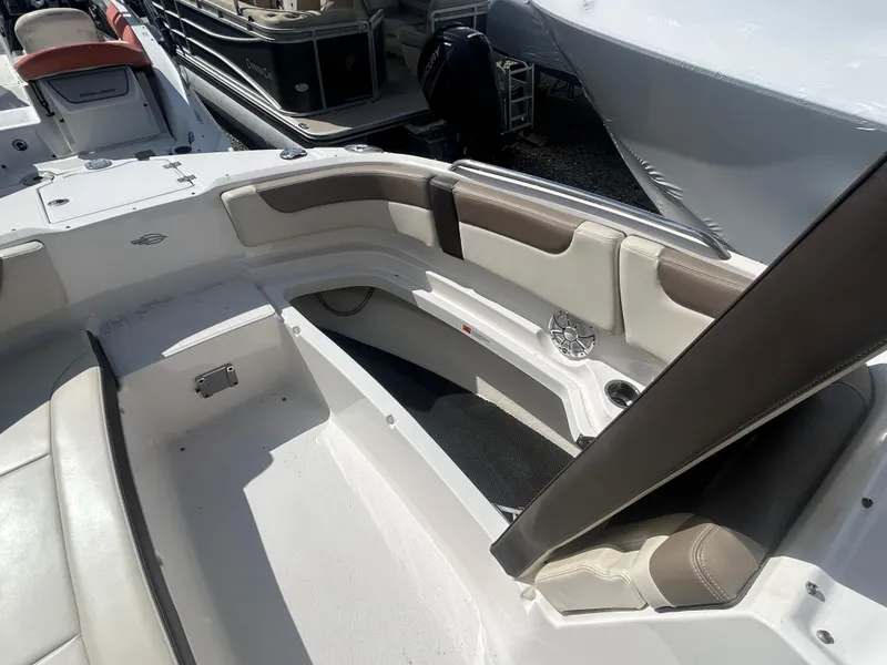 Slide: The Image of 2019 Chaparral 250 Suncoast boat interior with seating and storage compartments. - 37