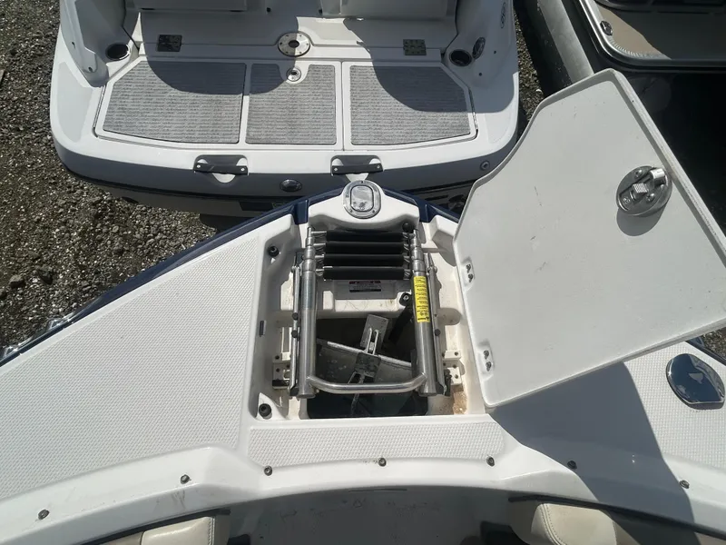 Slide: The Image of 2019 Chaparral 250 Suncoast boat with open storage compartment and ladder. - 42