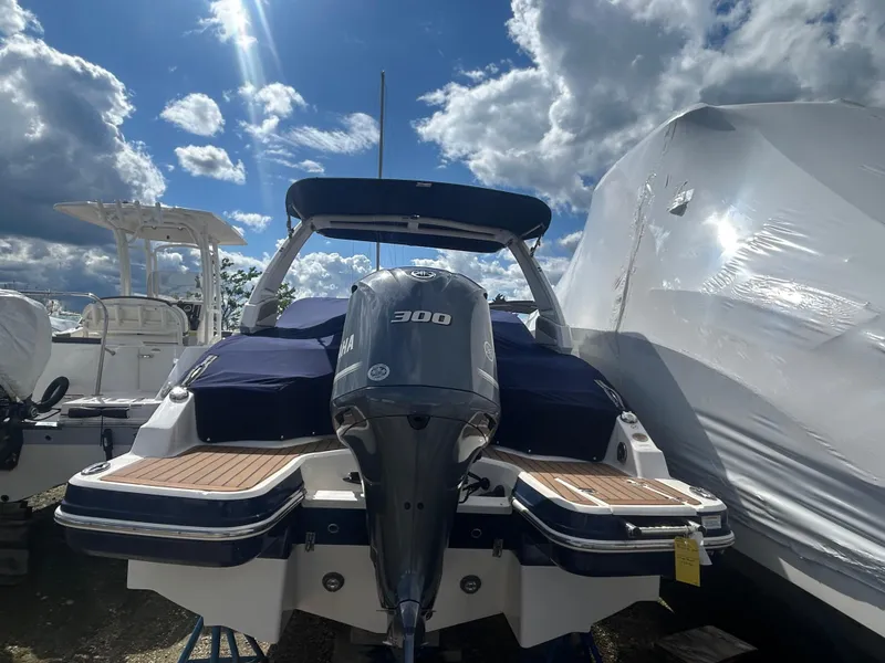 Slide: The Image of 2019 Chaparral 250 Suncoast boat with Yamaha 300 engine, docked under a cloudy sky. - 6