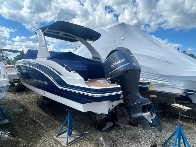 Slide: The Image of 2019 Chaparral 250 Suncoast boat with Yamaha engine, displayed outdoors on stands. - 7