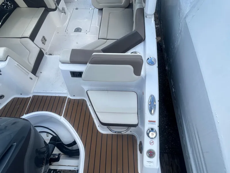 Slide: The Image of 2019 Chaparral 250 Suncoast boat interior with seating and deck details. - 8