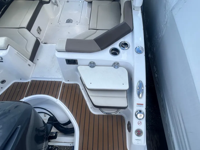 Slide: The Image of 2019 Chaparral 250 Suncoast boat interior with seating and deck details. - 9