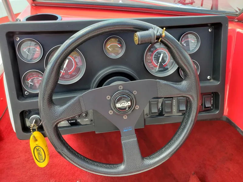Slide: The Image of Steering wheel and dashboard of 1993 Baja 204 Islander boat with gauges and controls. - 4