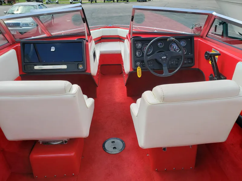 Slide: The Image of Interior of a 1993 Baja 204 Islander boat with red and white seating. - 5