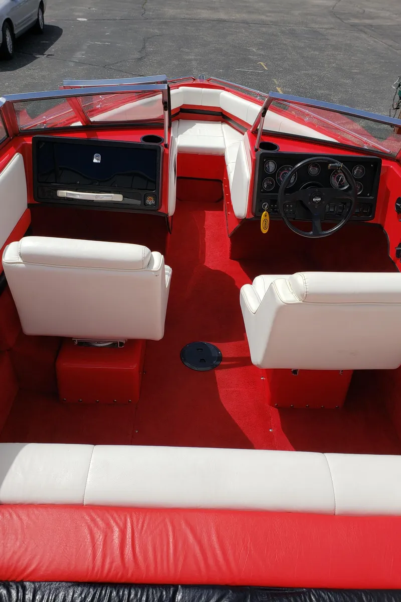 Slide: The Image of 1993 Baja 204 Islander boat interior with red and white seating and dashboard. - 7