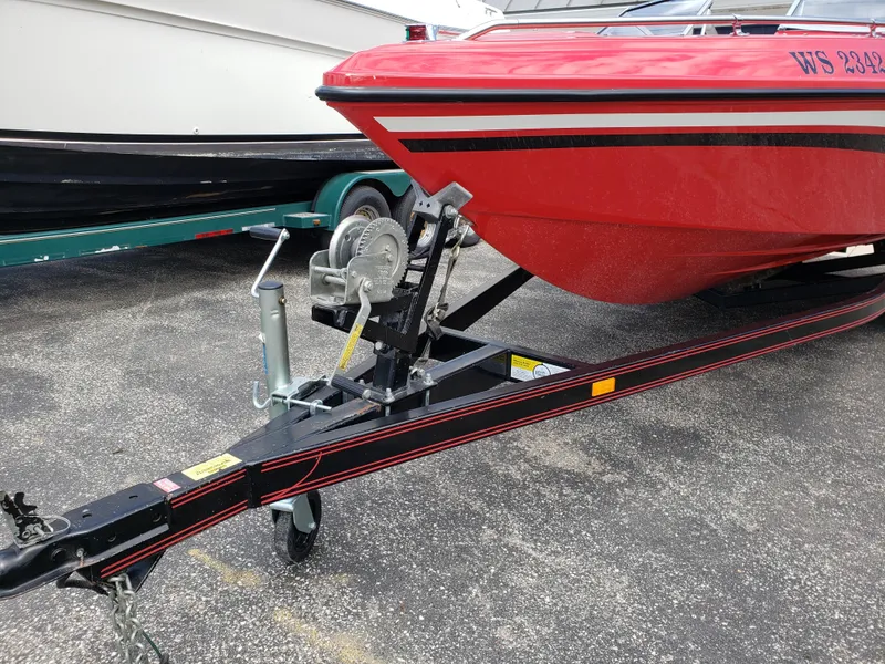 Slide: The Image of Red 1993 Baja 204 Islander boat on trailer, parked on asphalt. - 8