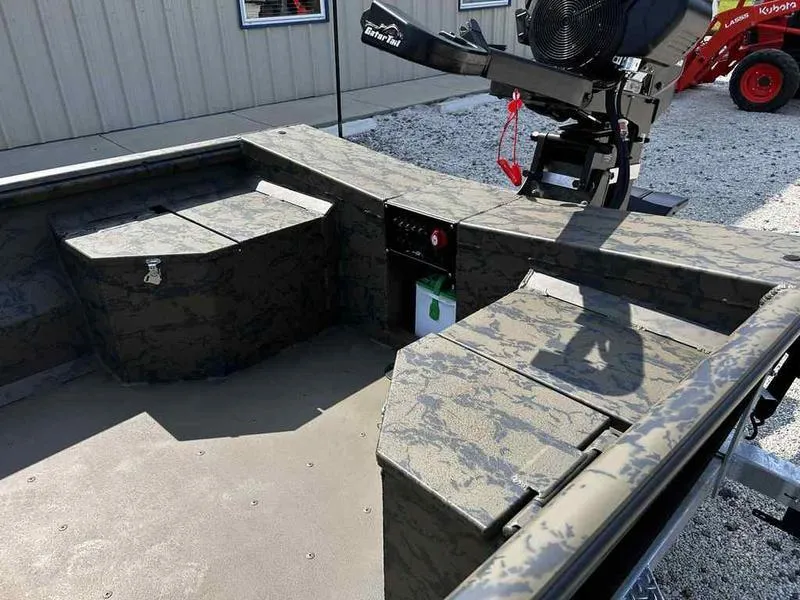Slide: The Image of 2025 Gator Tail 1754 Extreme Series boat interior with camouflage design and storage compartments. - 11