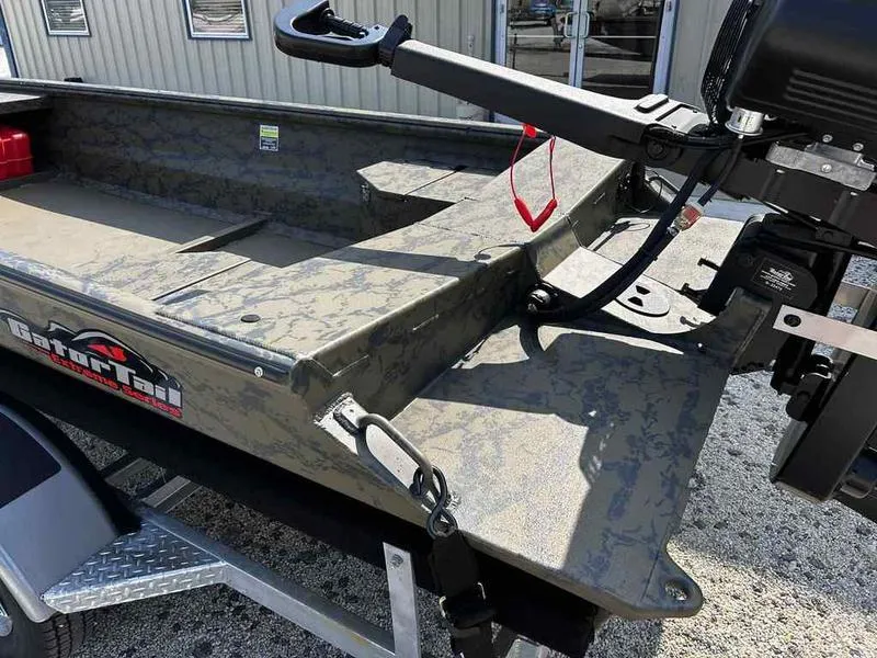 Slide: The Image of 2025 Gator Tail 1754 Extreme Series boat with camouflage design and motor, on a trailer. - 12