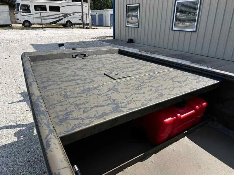 Slide: The Image of 2025 Gator Tail 1754 Extreme Series boat with camouflage design, parked outdoors. - 8