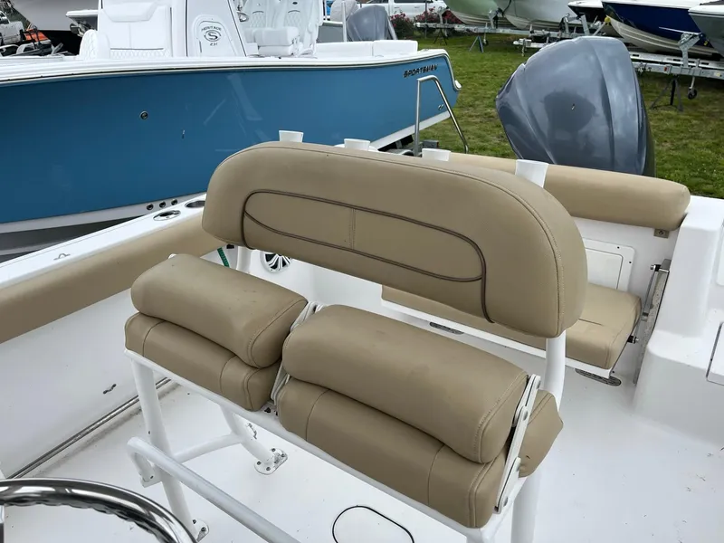 Slide: The Image of 2017 Sportsman Open 232 Center Console boat with tan seating and blue hull. - 11