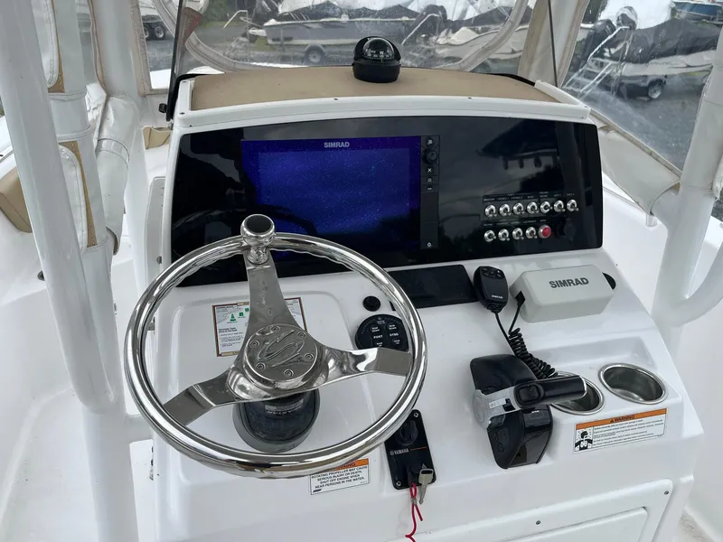 Slide: The Image of 2017 Sportsman Open 232 Center Console dashboard with steering wheel and navigation equipment. - 12