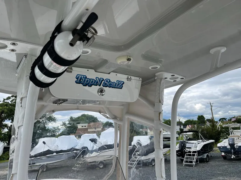 Slide: The Image of 2017 Sportsman Open 232 Center Console interior with fire extinguisher and "TippN ScalZ" sign. - 13