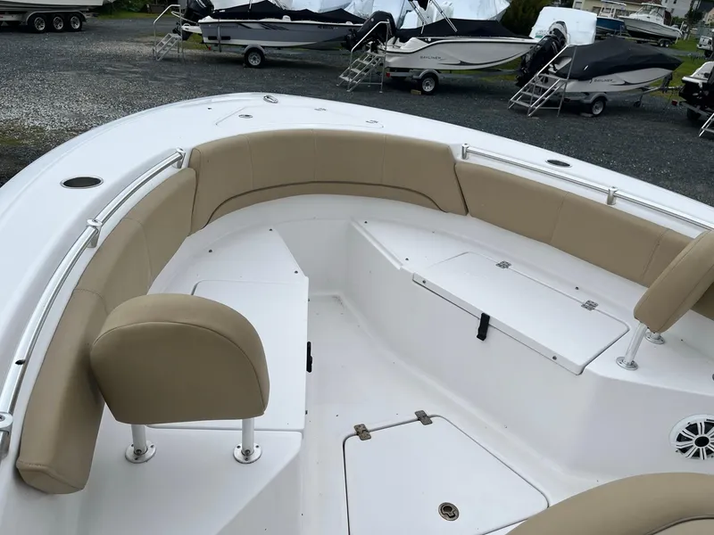 Slide: The Image of 2017 Sportsman Open 232 Center Console boat with beige seating and spacious deck. - 14