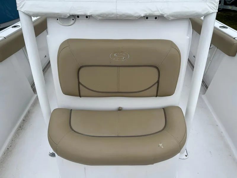 Slide: The Image of 2017 Sportsman Open 232 Center Console boat seat, tan upholstery, white frame. - 15