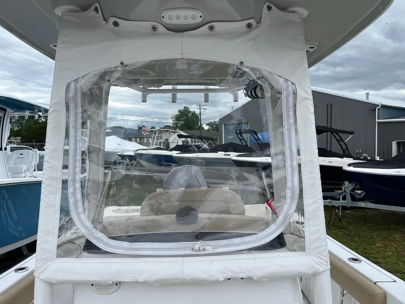 Slide: The Image of 2017 Sportsman Open 232 Center Console boat with protective enclosure, docked outdoors. - 16